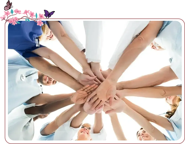 A group of people holding hands in the middle of a circle.