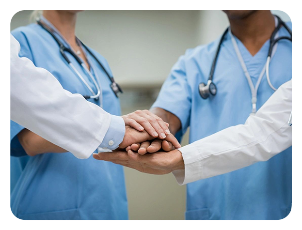 Three doctors are holding hands in a circle.